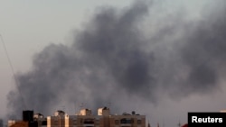 Khói đen bốc lên trời bên trên những khu vực diễn ra những vụ đụng độ giữa lực lượng ủng hộ chính phủ và phiến quân ở thành phố Benghazi, Libya, ngày 15 tháng 8, 2015. 