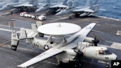 An E-2C Hawkeye lands on the deck of U.S. aircraft carrier USS George Washington during joint military drills between the U.S. and South Korea in the Yellow Sea, southwest of Seoul, June 24, 2012.