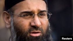 FILE - Muslim preacher Anjem Choudary and an associate are accused of using lectures published online to encourage support for Islamic State millitants.