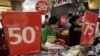 Employees prepare their clothes stall as they wait for customers at a shopping centre in Jakarta, August 6, 2012. 