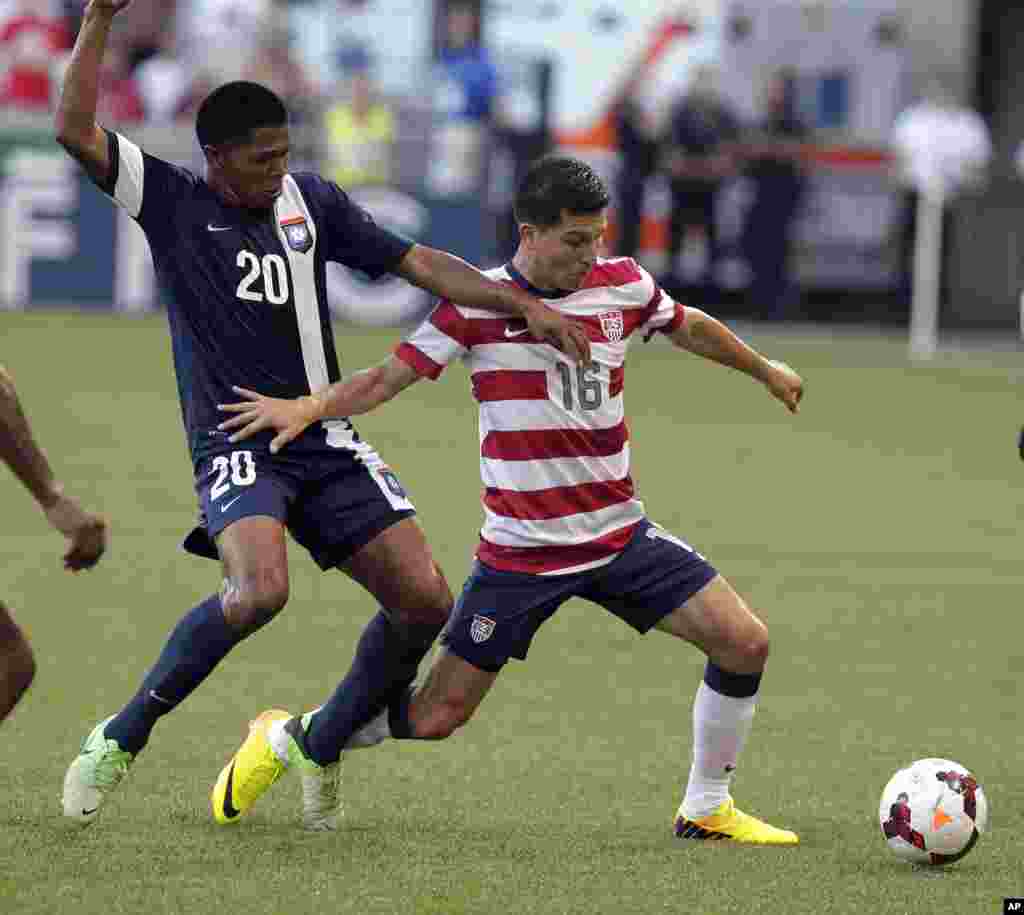 El estadounidense José Torres, escapa con la pelota ante la marca de Daniel Jiménez de Belize en el partido de primera ronda.