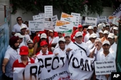 FILE - Indian people march during a "I Respect Women" walk for gender equality in New Delhi, India.