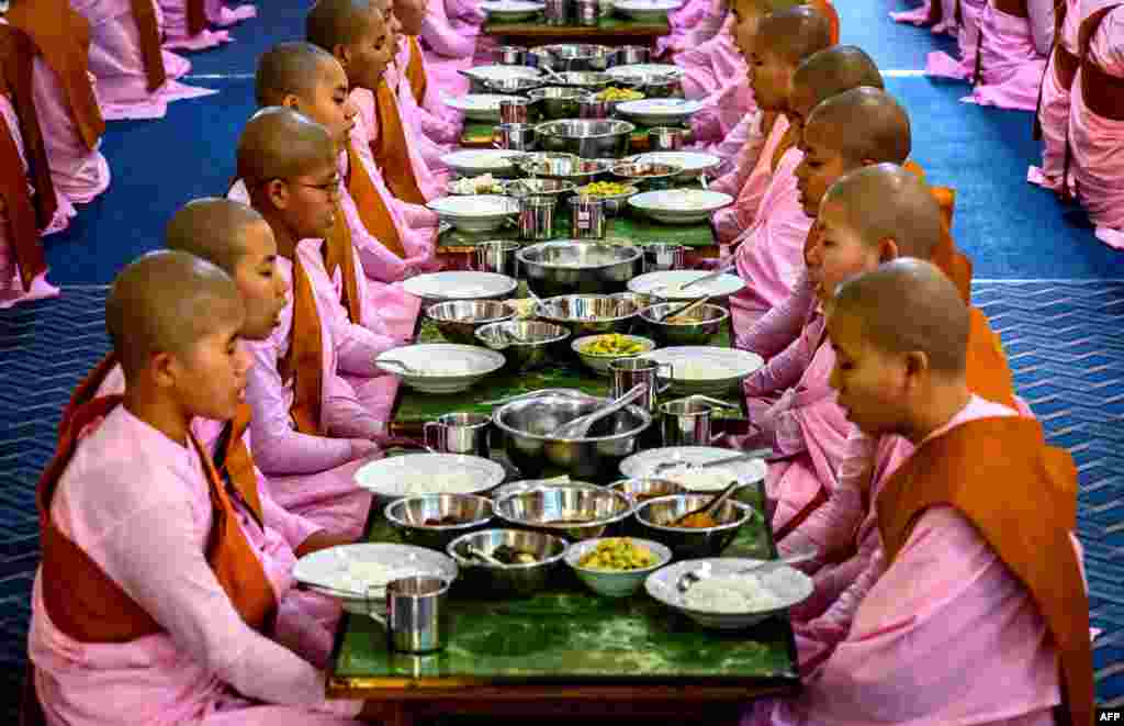 Buddhist novice nuns pray before breakfast at a monastic school in Sagaing outside Mandalay, Myanmar.