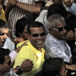 Mohamed Nasheed, center, who resigned Tuesday from his post as Maldivian president, marches along with his supporters during a rally in Male, Maldives, February 8, 2012.