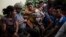 Families wait to be reunited with their children who were separated from them by U.S. immigration authorities, at the shelter "Nuestras Raíces" in Guatemala City, Tuesday, Aug. 7, 2018. 