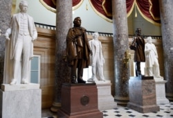 FILE - In this June 24, 2015, photo, a statue of Jefferson Davis, second from left, president of the Confederate States of America from 1861 to 1865, is on display in Statuary Hall on Capitol Hill in Washington.