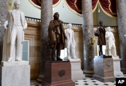 FILE - In this June 24, 2015, photo, a statue of Jefferson Davis, second from left, president of the Confederate States of America from 1861 to 1865, is on display in Statuary Hall on Capitol Hill in Washington.