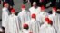 FILE - Pope Francis greets cardinals at the end of a mass for the beatification of former pope Paul VI in St. Peter's square at the Vatican, Oct. 19, 2014. 