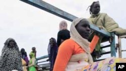 Internally displaced citizens ride a the truck carrying their belongings to return home after the Sudanese army took control of the area at Al-Damazin town at Blue Nile State, September 6, 2011.