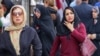 Women walk on a market street in Tehran on Sept. 15, 2024, on the second anniversary of a protest movement sparked by the death in custody of Mahsa Amini, arrested for allegedly violating the dress code for women. 