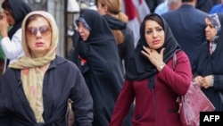 Women walk on a market street in Tehran on Sept. 15, 2024, on the second anniversary of a protest movement sparked by the death in custody of Mahsa Amini, arrested for allegedly violating the dress code for women. 