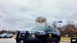 A Texas state trooper blocks traffic on a road leading to a Colleyville, Texas, synagogue where a man apparently took hostages, Jan. 15, 2022. 