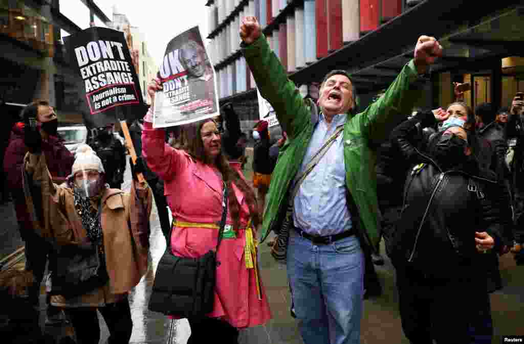 People celebrate outside the Old Bailey, the Central Criminal Court, in London, after a British judge ruled that WikiLeaks founder Julian Assange should not be extradited to the United States.