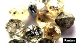 FILE - Rough diamonds are displayed at a valuing company in Gaborone, Botswana.