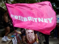 A Britney Spears supporter waves a "Free Britney" flag outside a court hearing concerning the pop singer's conservatorship at the Stanley Mosk Courthouse, Wednesday, June 23, 2021, in Los Angeles. (AP Photo/Chris Pizzello)