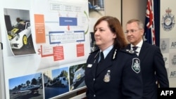 Australian Federal Police Deputy Commissioner Leanne Close leaves a press conference with Australian Taxation Office Acting Commissioner of Taxation Andrew Mills after the AFP smashed a massive tax fraud syndicate and seized planes, guns and luxury cars, in Sydney, May 18, 2017. A top-ranking tax official and his son were among those held after raids on homes and businesses across New South Wales state on May 17.