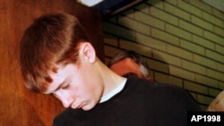 FILE - In this May 22, 1998, photo, Thurston High School student Kip Kinkel, 15, is led to his arraignment in Eugene, Ore. 