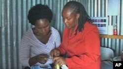 Peer educator Susan Mwangi explains the finer points of reproductive health, Kenya, April 26, 2011. 