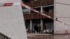 A police line blocks the way as officers stand guard in front of the Aksehir bar where a grenade was thrown the night before in the Grenoble Olympic Village, part of La Villeneuve district, in Grenoble, France, on Feb. 13, 2025. 