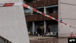 A police line blocks the way as officers stand guard in front of the Aksehir bar where a grenade was thrown the night before in the Grenoble Olympic Village, part of La Villeneuve district, in Grenoble, France, on Feb. 13, 2025. 