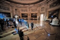 House impeachment managers walk the article of impeachment against former President Donald Trump through the Rotunda of the US Capitol in Washington, Jan. 25, 2021.