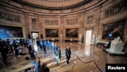 House impeachment managers walk the article of impeachment against former President Donald Trump through the Rotunda of the US Capitol in Washington, Jan. 25, 2021.