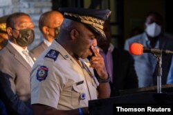 Head of Haitian National Police, Leon Charles, pauses during a news conference in Port-au-Prince