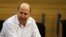 FILE - Moshe Yaalon attends a Likud-Beiteinu party meeting at the Knesset, the Israeli parliament, in Jerusalem, March 14, 2013. 