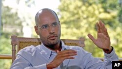 Saif al-Islam, son of Libyan leader Moammar Gadhafi, indicates that Libya plans an enhanced oil recovery round to develop its production capacity during an interview with Reuters, in Nice, France, July 30, 2007 (file photo)