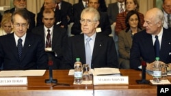 Italian Premier Mario Monti, center, is flanked by Foreign Minister Giulio Terzi di Sant'Agata, left, during a meeting in Rome, December 15, 2011.