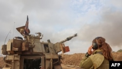 FILE - An Israeli artillery unit is pictured near the border with the Gaza Strip on December 5, 2023, amid continuing battles between Israel and the militant group Hamas.