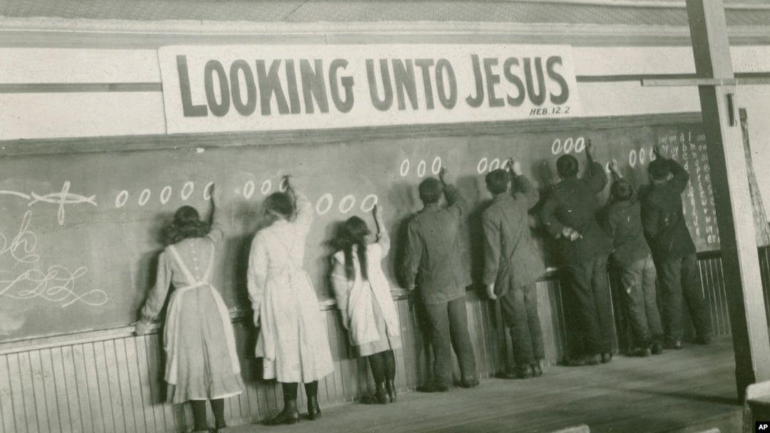 FILE - In this 1910s photo provided by the United Church of Canada Archives, students write on a chalkboard at the Red Deer Indian Industrial School in Alberta.