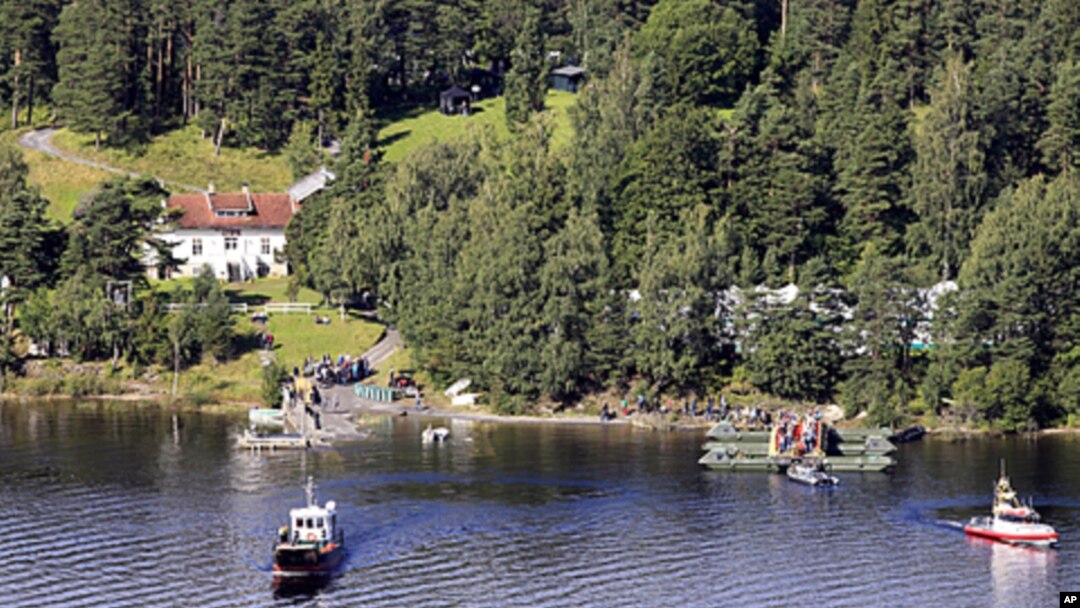 A picture taken from a farm on the coast of Hole shows survivors of the July 22 attacks in Norway gathering on Utoeya island during a visit on August 20, 2011