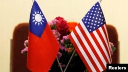 FILE - Flags of Taiwan and the United States are in place for a meeting between U.S. and Taiwanese legislators in Taipei, March 27, 2018.