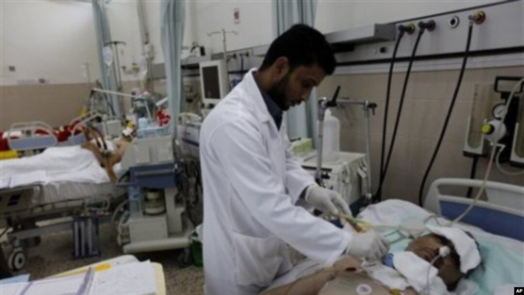 A Libyan doctor treats a wounded man who was injured last week during the demonstration against Libyan Leader Moammar Gadhafi, in Benghazi, Libya, February 24, 2011