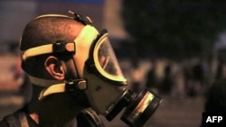 A protester wears a gas mask during anti-government protests in the Shi'ite shrine city of Karbala, south of Iraq's capital Baghdad, late on Oct. 28, 2019.