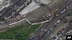 FILE - Emergency personnel work at the scene of a deadly train derailment in Philadelphia, May 13, 2015.