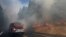 A fire truck drives past burning trees as firefighters continue to battle the Rim Fire near Yosemite National Park, California, Aug. 26, 2013