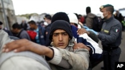 A man fleeing the unrest in Tunisia looks on as he and others arrive at the southern Italian island of Lampedusa (file photo)