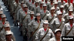 Militia members stand at attention during a ceremony with Venezuela's President Nicolas Maduro at Miraflores Palace in Caracas, April 17, 2017.