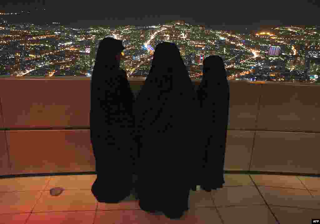 Iranian women stand on Tehran's telecommunication tower before a ceremony to mark the 32nd anniversary of Iran's Islamic revolution, February 11, 2011. (Reuters)