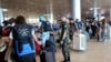 FILE - A Brazilian officer directs Brazilians as they check in to leave Israel, from Ben Gurion International Airport near Tel Aviv on Oct. 14, 2023, amid the ongoing battles between Israel and the Palestinian group Hamas.