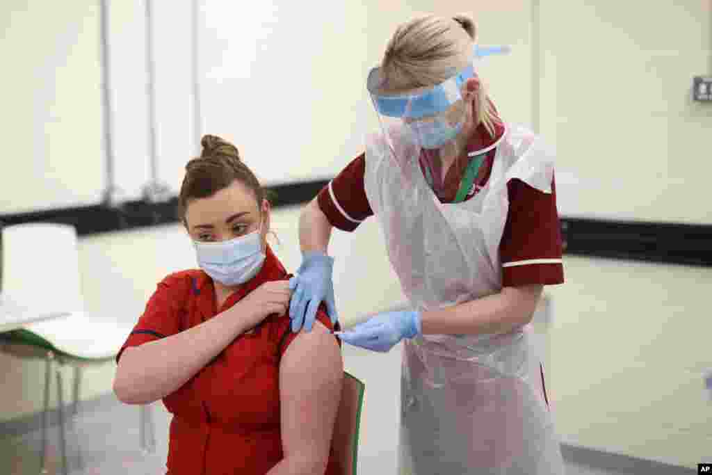 Sister Joanna Sloan receives the Pfizer-BioNTech COVID-19 vaccine, as the first person in Northern Ireland at the Royal Victoria Hospital, in Belfast, Dec. 8, 2020.