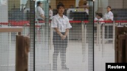 A demonstration of a security check for the Guangzhou-Shenzhen-Hong Kong Express Rail Link is performed at the West Kowloon Terminus, in Hong Kong, July 26, 2018.