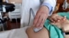 FILE - A doctor performs an ultrasound scan on a pregnant woman on Aug. 7, 2018, at a hospital in Chicago.