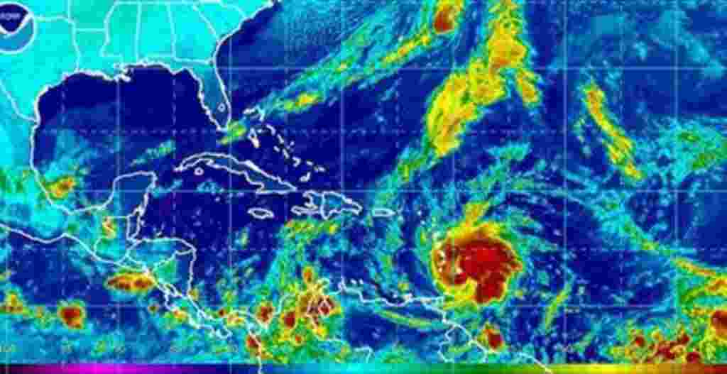 This image provided by NOAA shows Tropical Storm Tomas, lower center, taken early Saturday morning 30 Oct 2010