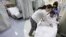 FILE - Nurses at University of Chicago Medical Center in Chicago are seen tending to a patient.