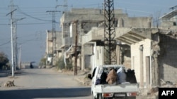 FILE - Residents flee the town of Morek as anti-regime fighters advance on a road leading to the Hama province in central-west Syria on Dec. 1, 2024. The insurgents led by Hayat Tahrir al-Sham took over most of Aleppo on Saturday and claimed to have entered the city of Hama.