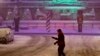 A pedestrian walks across an intersection as snow falls in downtown Indianapolis, Dec. 15, 2019. 