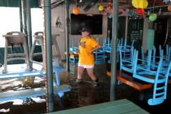 Robyn Iacona-Hilbert walks through her flooded business after Hurricane Barry in Mandeville, La., July 13, 2019.